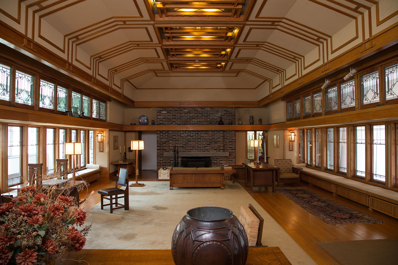 Large living room with oak trim and geometric windows