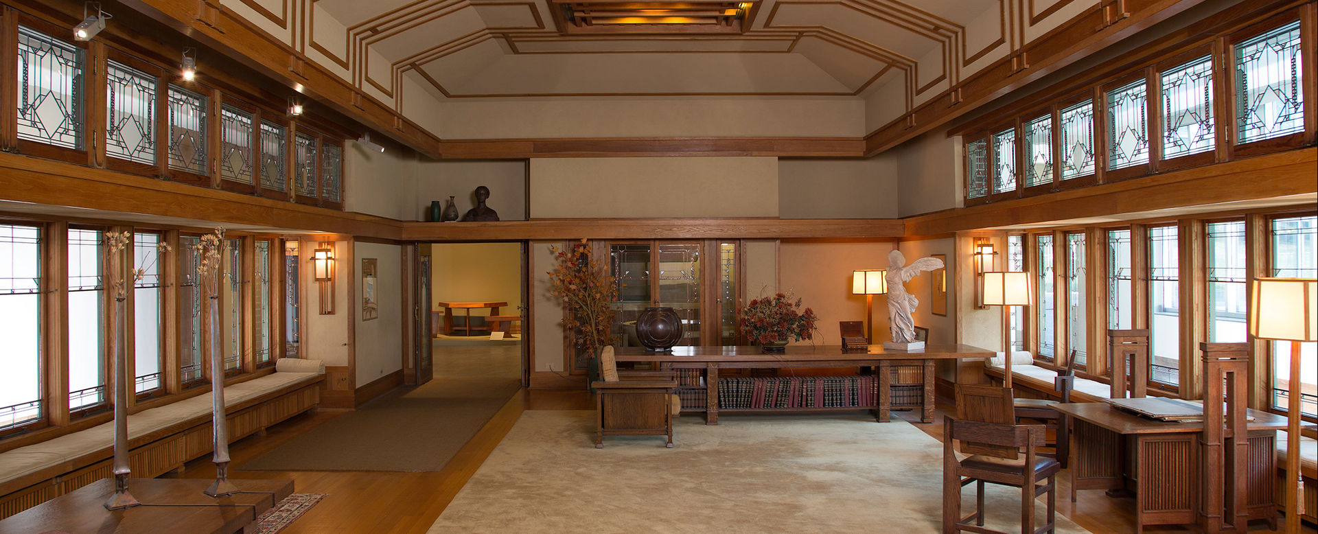 Large living room with oak trim and geometric windows designed by Frank Lloyd Wright