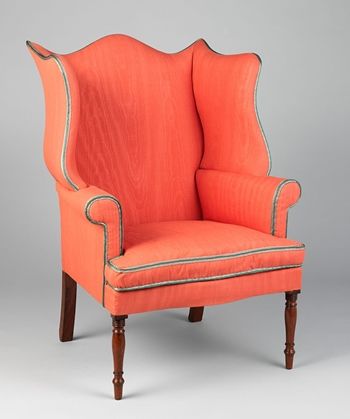 An easy chair with red-orange upholstery tapered mahogany legs 