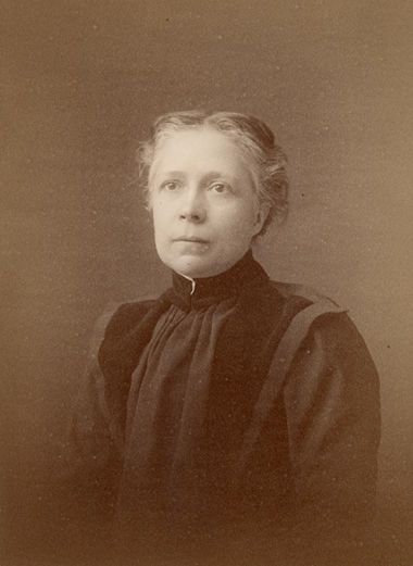 Photographic portrait of  Sarah Mazella Luke Gallup wearing a dark garment with a high neck