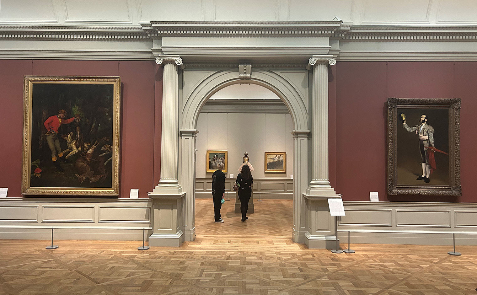 A view of Galley 810, looking into Gallery 815. Flanking the doorway are two paintings,  Courbet's "After the Hunt" on the left and Manet's "A Matador" on the right.