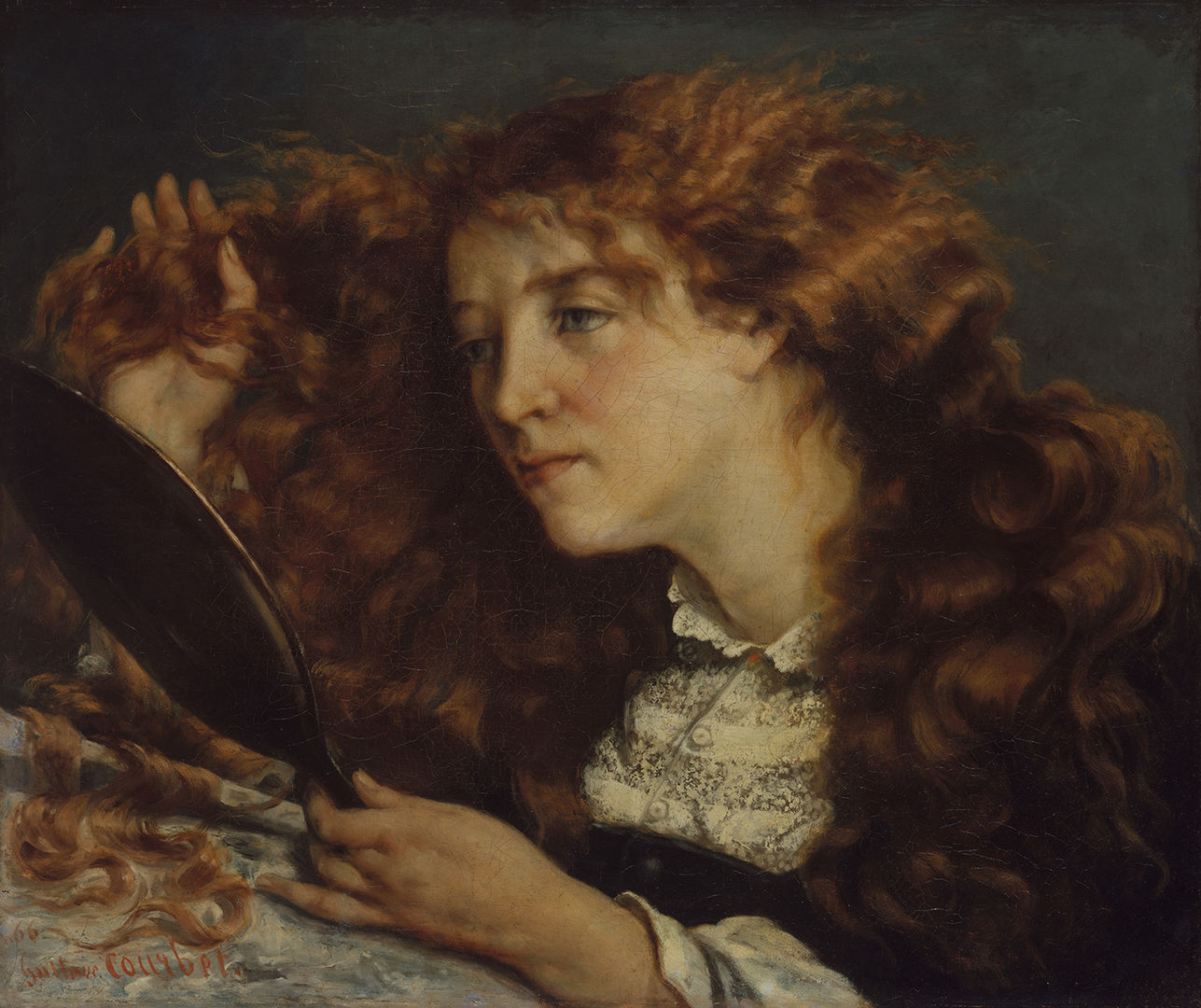A detail of  Gustave Courbet's  "Jo, La Belle Irlandaise". A young, red haired woman facing left, combs her fingers though her long hair while staring into a hand mirror. 