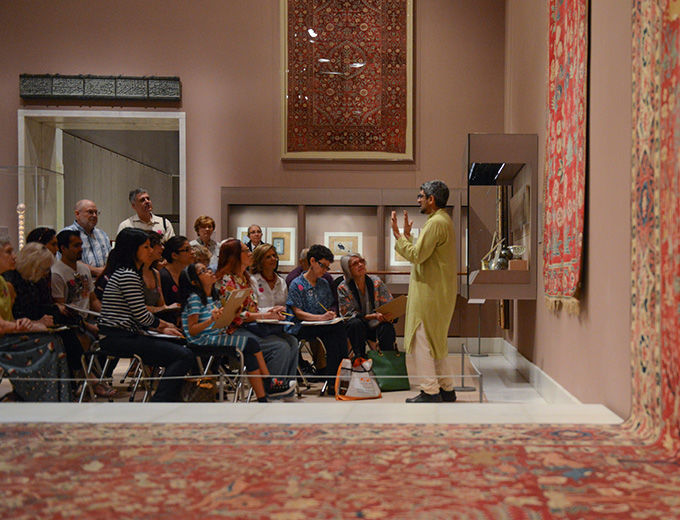 Visitors listening to a gallery talk about Persian objects