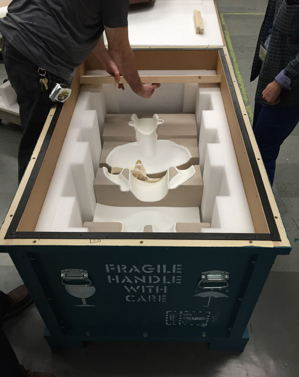 Conservators and technicians prepare the crate for shipment