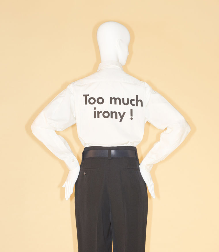 High-waisted black pants with a short-sleeve shirt with the text "Too much irony!"