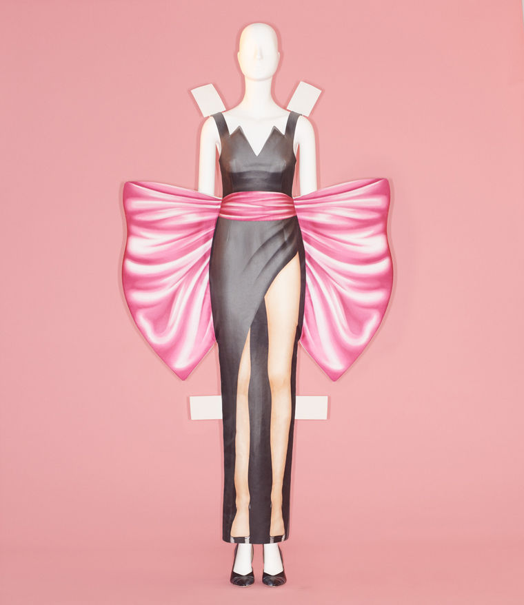 Couture ensemble comprising a black, form-fitting dress with an extravagant pink-and-white section around the waist