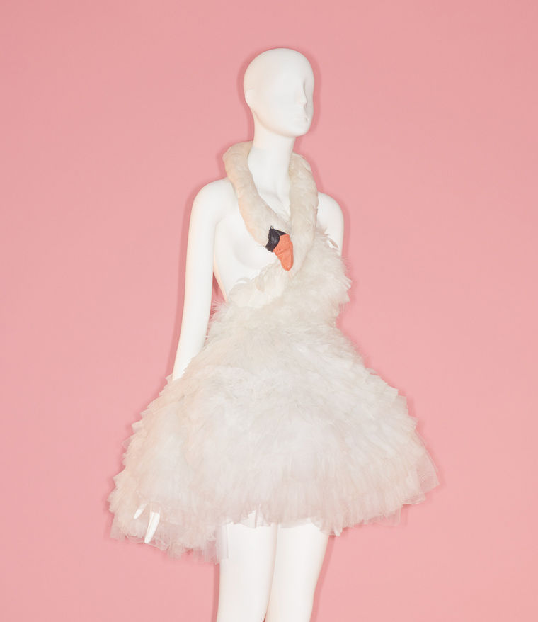 Couture dress in the shape of a swan with its neck wrapped around the mannequin's neck
