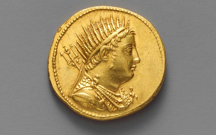 An ancient Greek gold coin, featuring the profile of Ptolemy IV Philopator, the fourth Pharaoh of Ptolemaic Egypt.