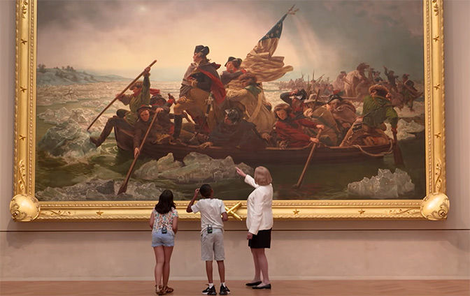 Curator Betsy Kornhauser and a young boy and girl look up at Washington Crossing the Delaware by Emanuel Leutze