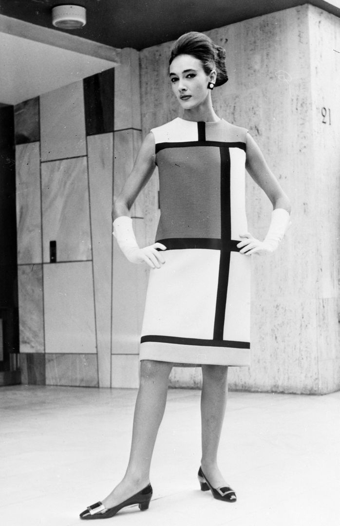 Black and white photograph of a model posing with the Mondrian dress designed by Yves Saint Laurent
