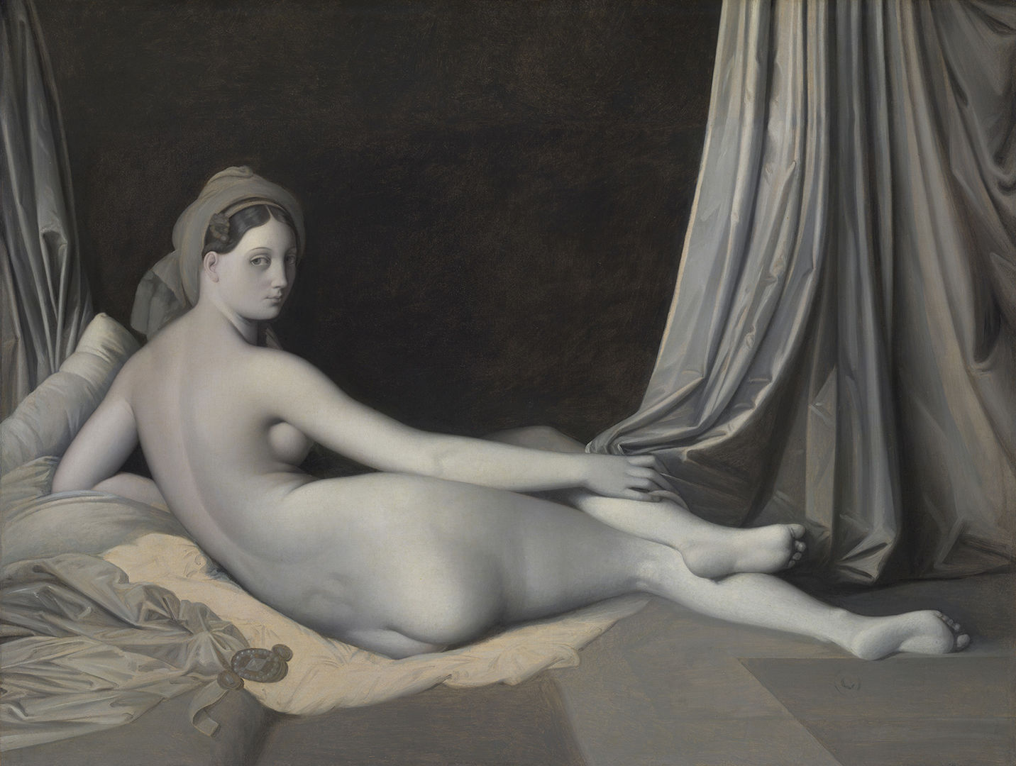 A nude woman reclines in a bed. Her back faces the viewer, but her head is turned towards the audience. Heavy drapes frame the image. 