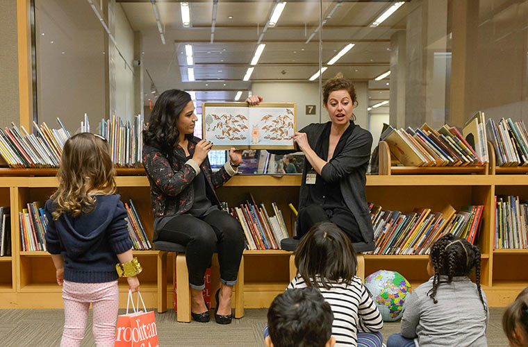 Met educators reading a children's book to a group of toddler's in The Met's Nolen Library