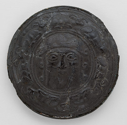 Roundel with the head of a hero surrounded by caprids