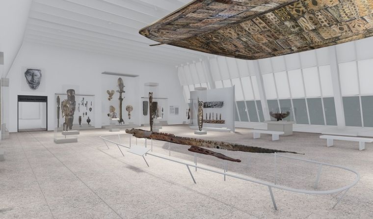 A large hollow panel like a boat's hull hangs from a brightly lit ceiling in a large gallery with  various wooden figurines