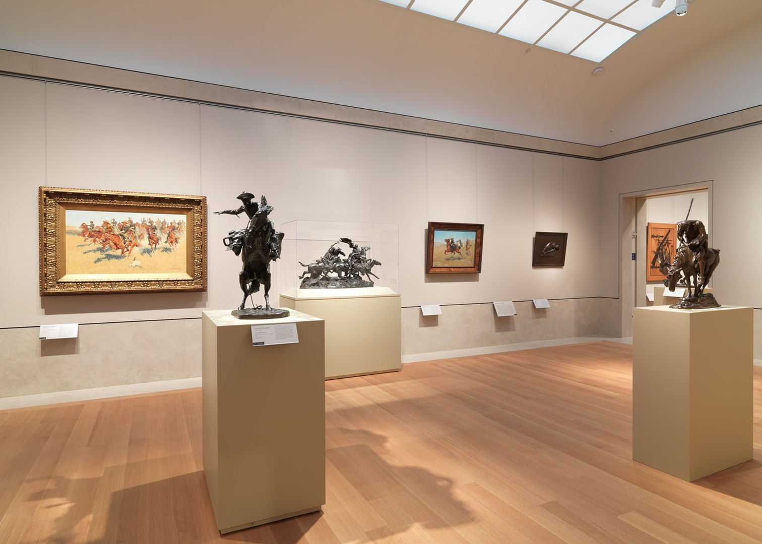 A gallery at The Met with sculptures and paintings depicting the American West