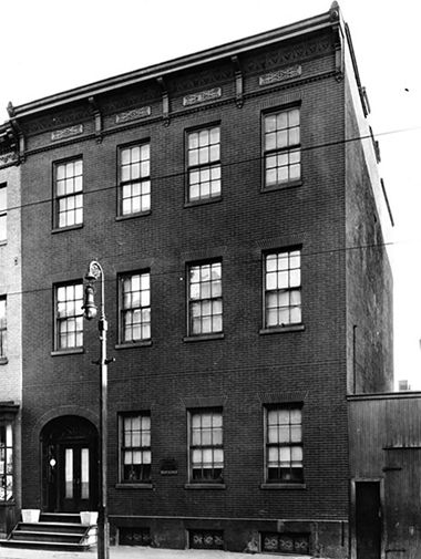 Archival photograph of the Craig House on Pratt street, a three story brick exterior