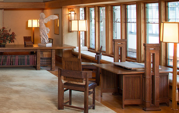 Large living room with oak trim and geometric windows