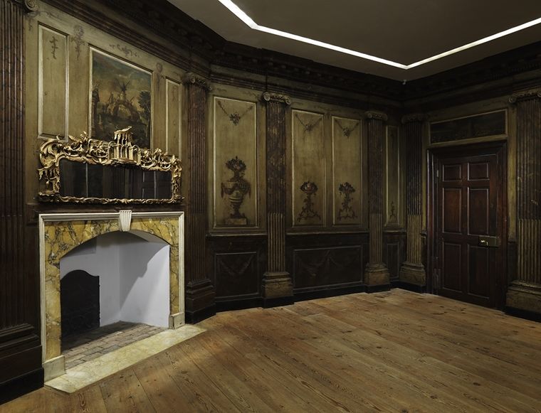 A photograph of the decorative panels, fireplace, and looking glass installed in the Marmion room in the American Wing of the Met.