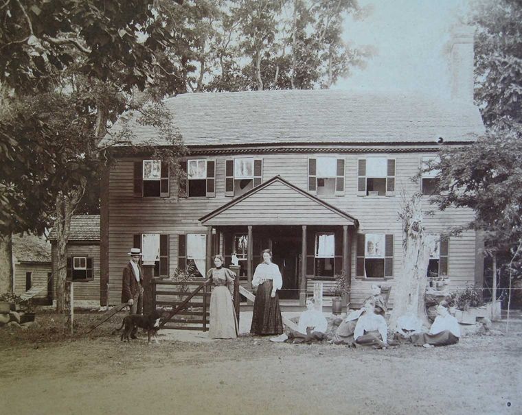 An archival photograph of the Lewis family and their home.