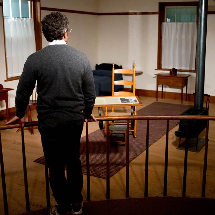 Sculptor Tom Sachs stands with his back to camera looking at the Shaker Room