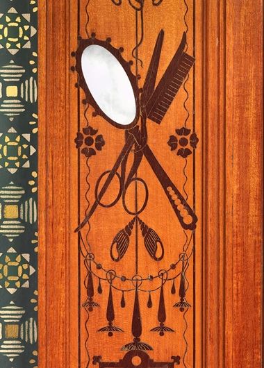 Wood paneling with inlay depicting a comb, mirror, scissors, and abstract embellishments.