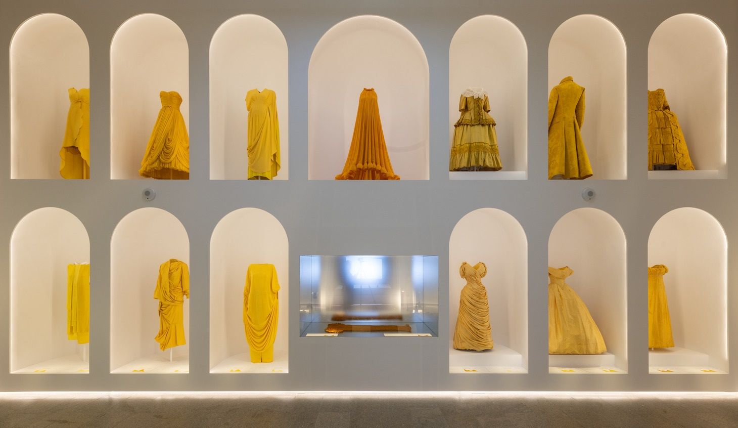 Golden dresses arrayed in a two tier alcove