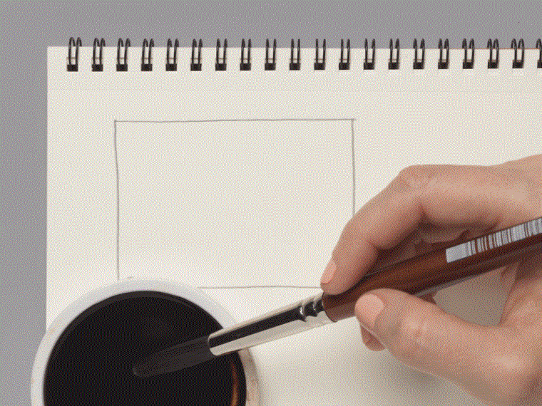 A moving image of a wide brush marking a dark ink mark on a notebook page, and then a metal blade removing slices of the ink.