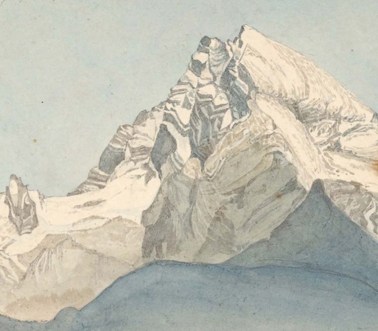 A detail of a snowy, jagged mountaintop against a light-blue sky