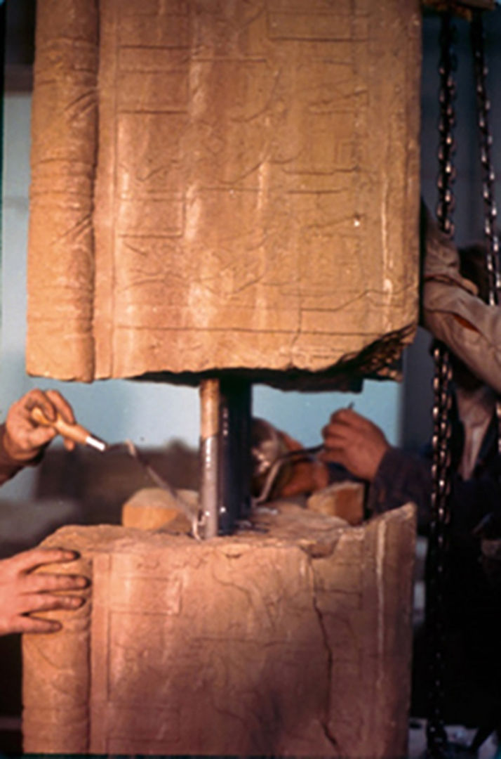 A colored photograph showing two fragments of the temple being joined with steel rods and epoxy.