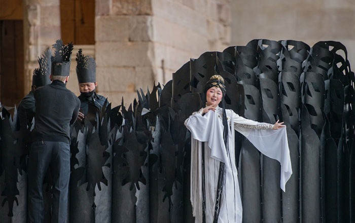 An opera singer performs in front of an Egyptian temple in The Met's galleries