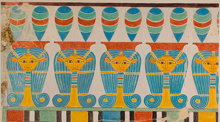 Colorful image with women's heads wearing curled wigs.