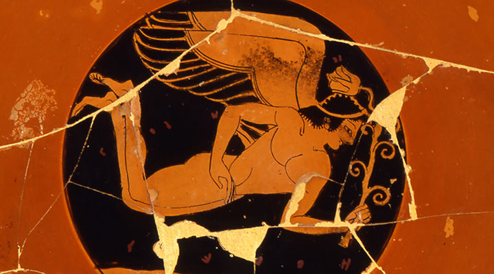 Inside of red cup showing winged Eros in flight against a black ground