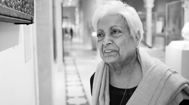Zarina Hashmi looking at an object in the Islamic Art wing at The Met.