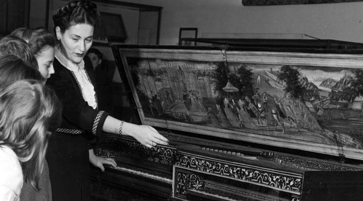 A group of schoolchildren view a double virginal from The Met collection