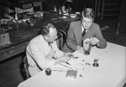 Dietrich von Bothmer and Frank Falson reassembling an ancient lethykos, 1949