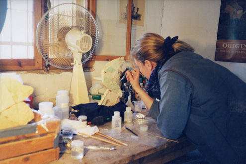 Conservator Ann Heywood consolidating pigment on relief fragment from the temple of Amenemhat III, Dahshur (Egypt), late 1990s