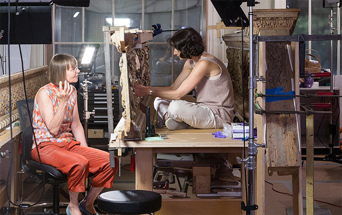Two conservators in their lab staining wood paneling for the British Galleries