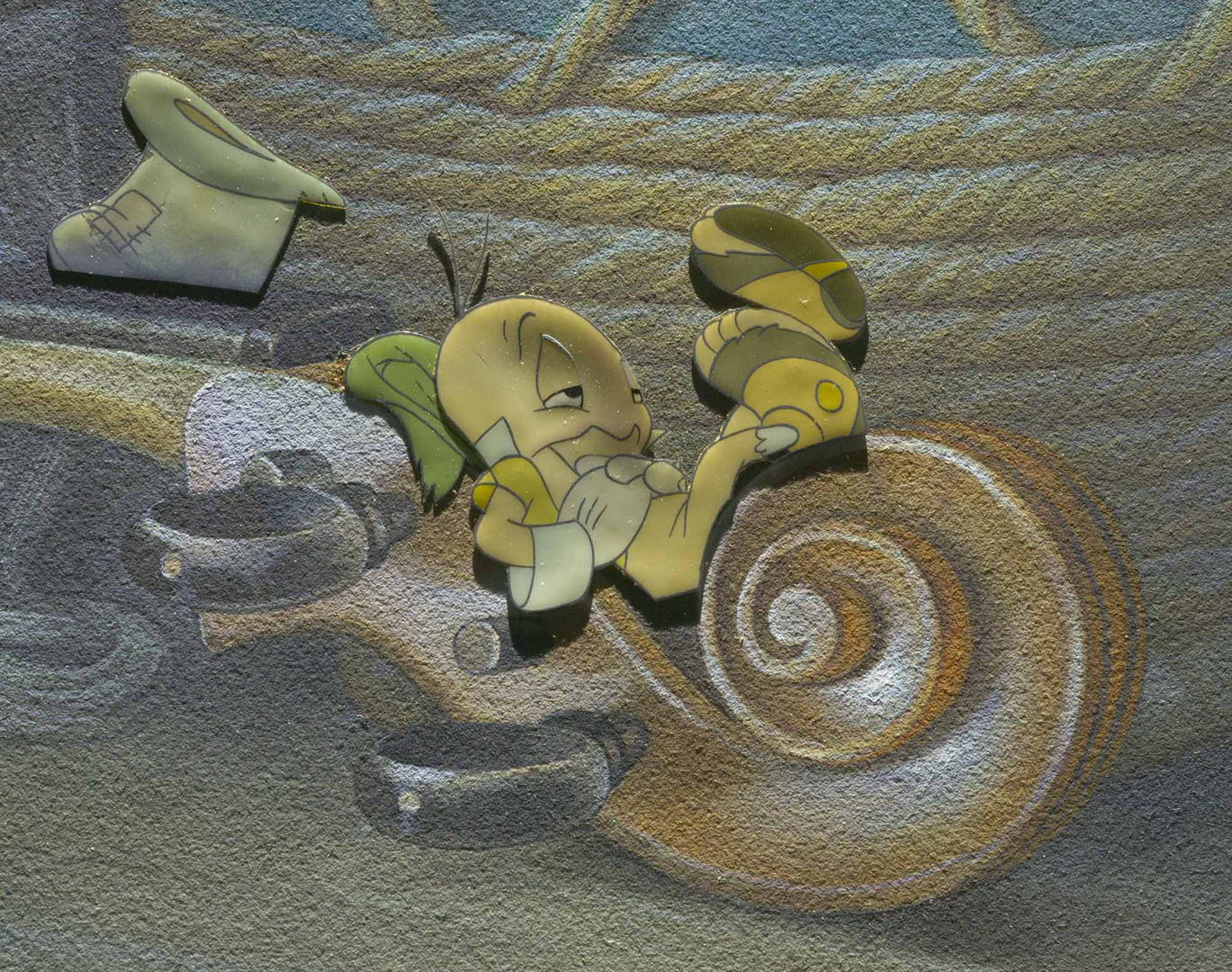 A drawing of a cricket resting on the neck of a cello.