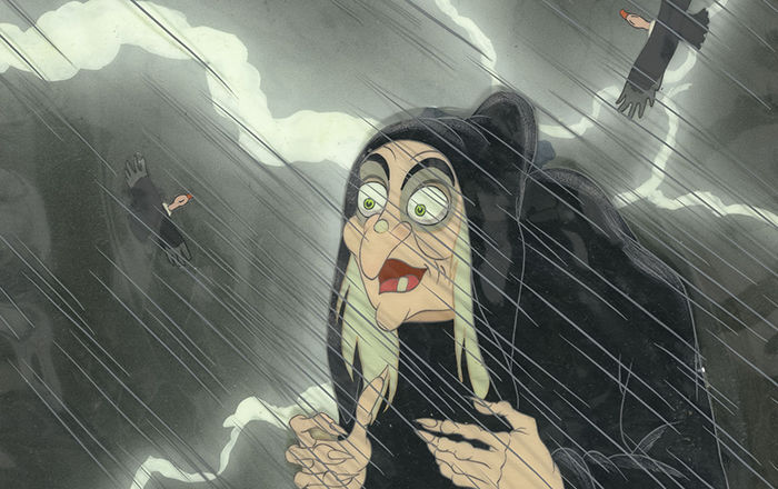 A witch in the rain with vultures flying overhead.