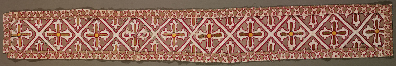 An image of a tapestry band. The band consists of diamond shapes and crosses.