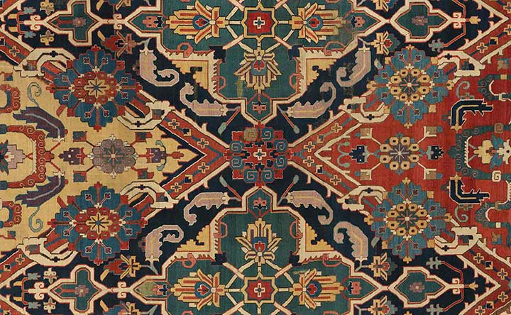 Detail from a symmetric orange, yellow, and blue tapestry