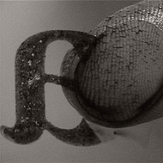 Pad of a finger wiping away the letter "a" printed on glass