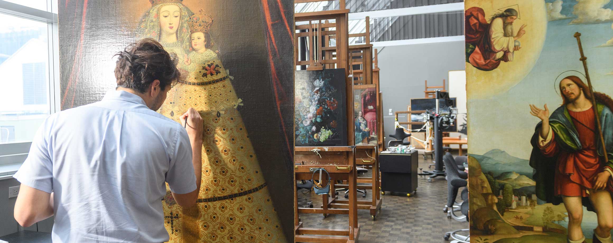 Paintings conservation fellow working on a royal portrait painting