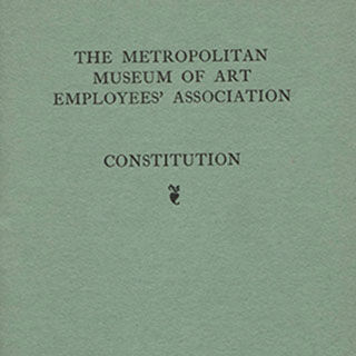 Detail of a book cover with the words "THE METROPOLITAN MUSEUM OF ART EMPLOYEES' ASSOCIATION CONSTITUTION" stamped in black on light green cloth