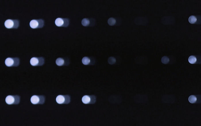 A series of illuminated bulbs against a dark background