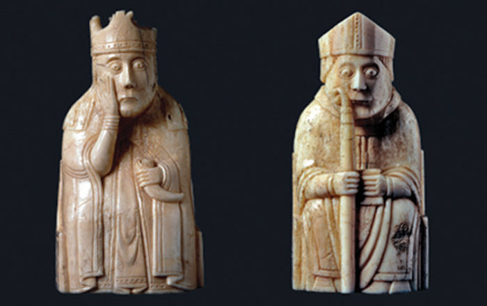 Two ivory kings sit with shocked expressions on their faces