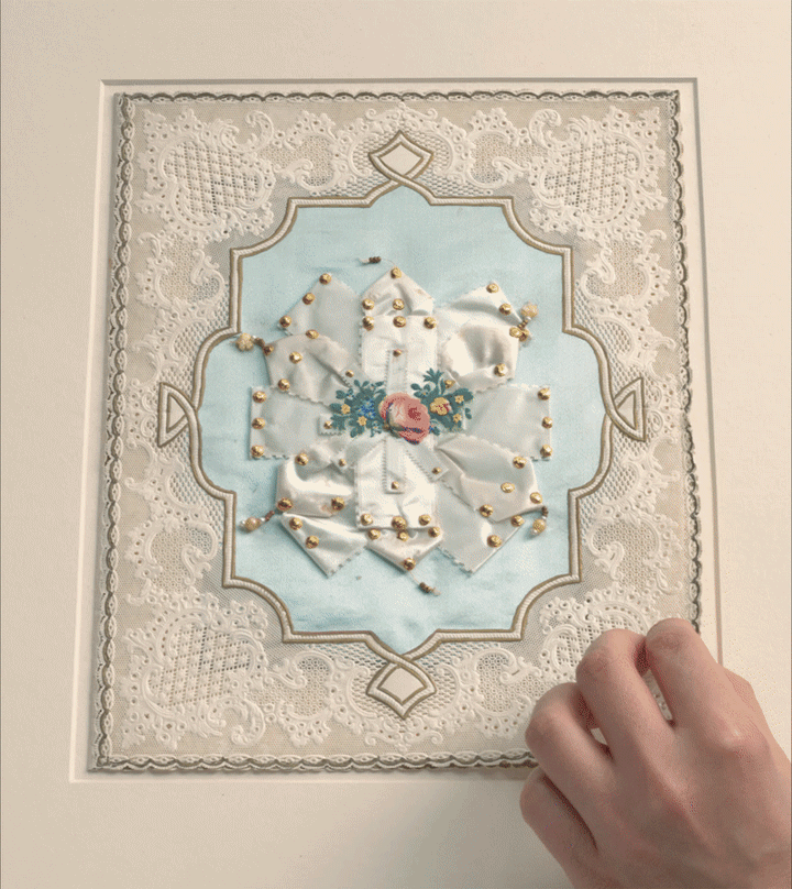 GIF of a 19th-century American lace-paper valentine being intricately unfolded to reveal additional layers