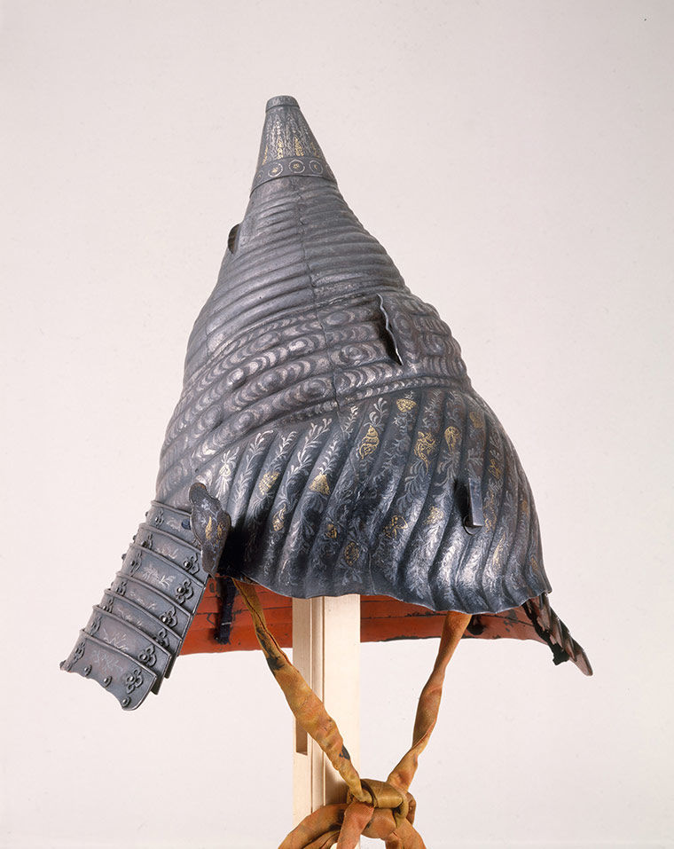A gray helmet made from the shell of a conch.