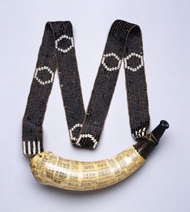 A Native American powder horn and shoulder belt