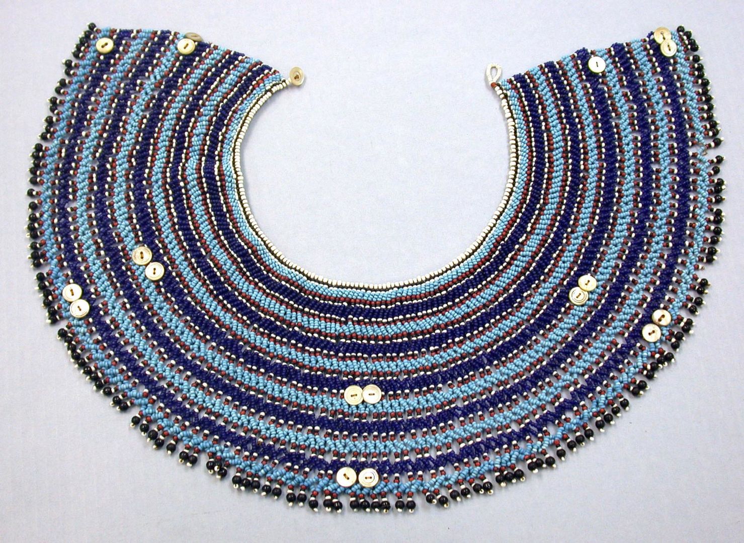 A South African collar made by the Xhosa or Mfengu or Nguni peoples made of beads, fiber, buttons, and leather